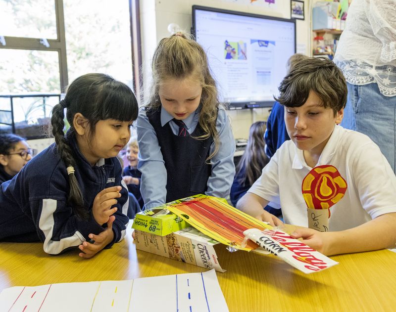 Pupils building a model from boxes and card