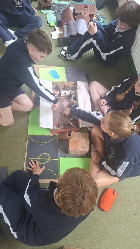Working on a model town on the classroom floor