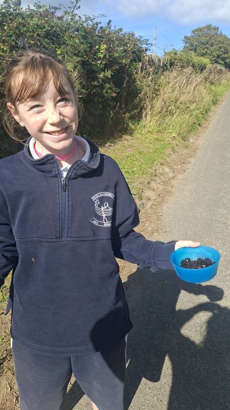 A smiling pupil on a nature walk down the lane
