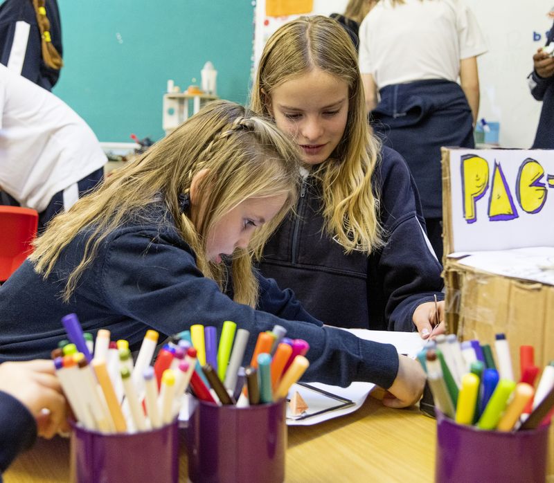 Pupils drawing with pots of markers