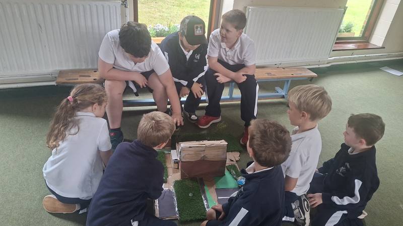 Gathered round a model village