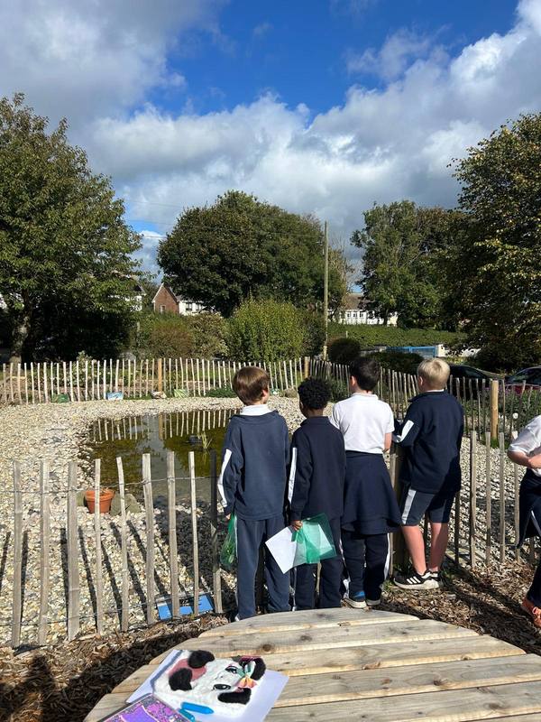 A class visiting the wildlife pond