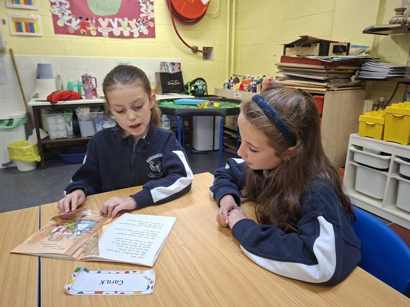 Two pupils reading together
