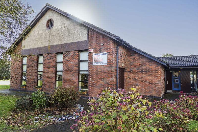 The front of the school with flowers in bloom