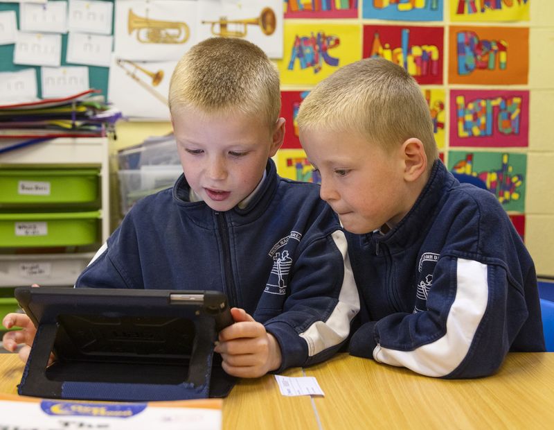 Two boys sharing a tablet