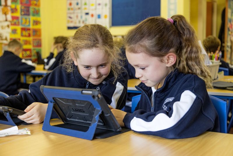Two girls working together on a tablet
