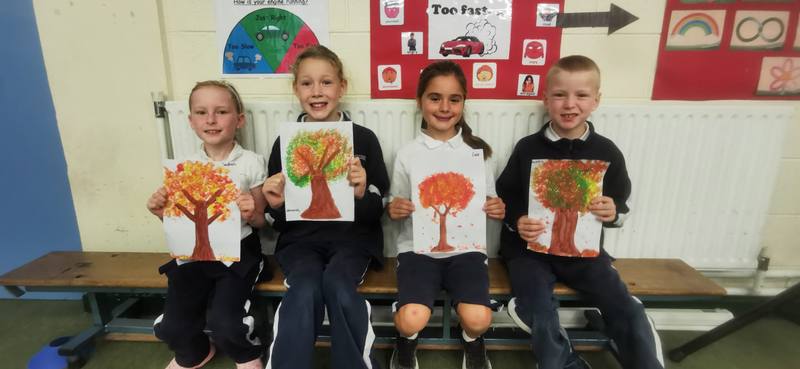 Infants with their autumn tree paintings