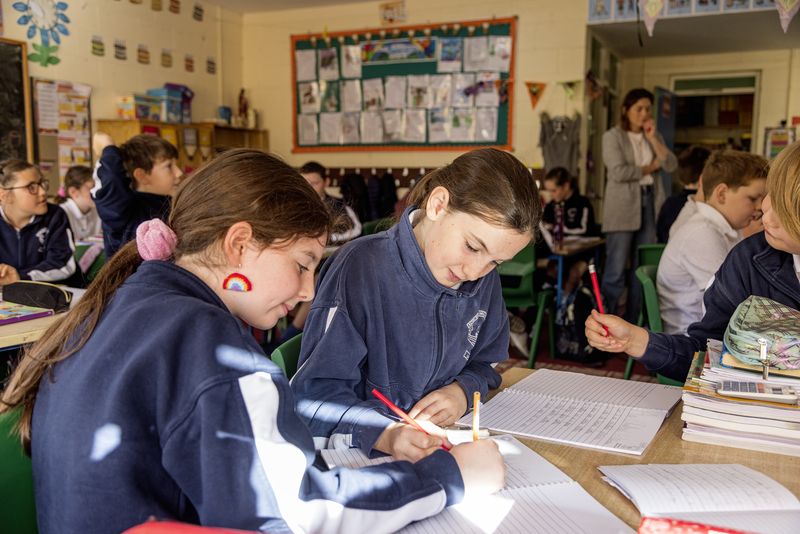 Pupils busy writing at their desks